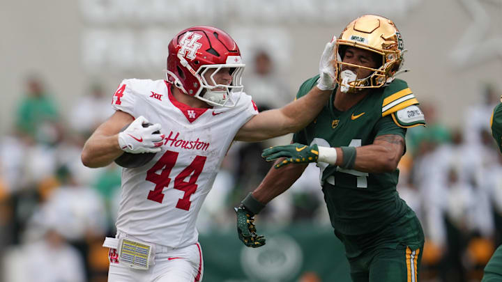Nov 29, 2025; Waco, Texas, USA;  Houston Cougars running back Dean Connors (44) carries the ball against Baylor Bears safety Micah Gifford (24) during the second half at McLane Stadium. Mandatory Credit: Chris Jones-Imagn Images
