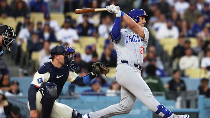 Apr 25, 2026; Los Angeles, California, USA; Chicago Cubs outfielder Michael Conforto (20) hits a single and Los Angeles Dodgers center Dalton Rushing (68) watches the play during the seventh inning at Dodger Stadium. Mandatory Credit: Kiyoshi Mio-Imagn Images