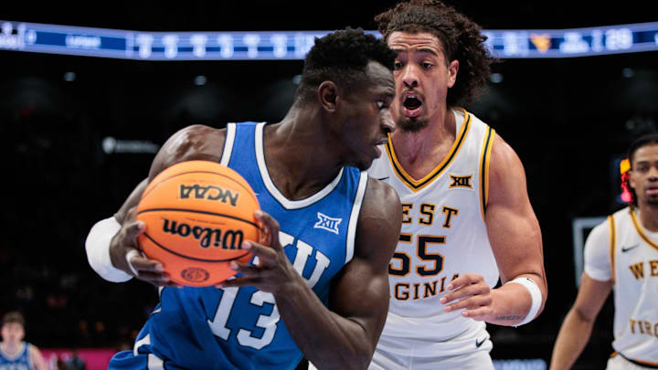 Mar 11, 2026; Kansas City, MO, USA; BYU Cougars forward Keba Keita (13) drives to the basket around West Virginia Mountaineers center Harlan Obioha (55) during the second half at T-Mobile Center. Mandatory Credit: William Purnell-Imagn Images Mar 11, 2026; Kansas City, MO, USA; BYU Cougars forward Keba Keita (13) drives to the basket around West Virginia Mountaineers center Harlan Obioha (55) during the second half at T-Mobile Center. Mandatory Credit: William Purnell-Imagn Images