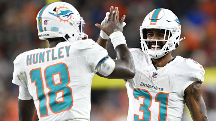 Miami Dolphins QB Tyler Huntley (18) and RB Raheem Mostert (31)