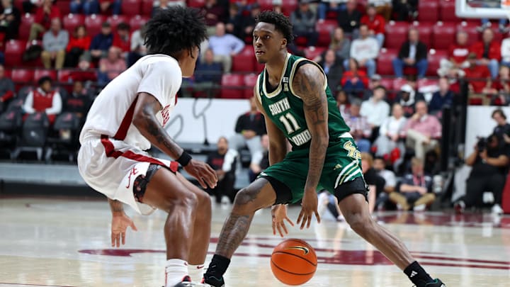 Dec 17, 2025; Tuscaloosa, Alabama, USA; South Florida Bulls guard CJ Brown (11) dribbles against Alabama Crimson Tide guard Aden Holloway (2) during the second half at Coleman Coliseum. Mandatory Credit: David Leong-Imagn Images