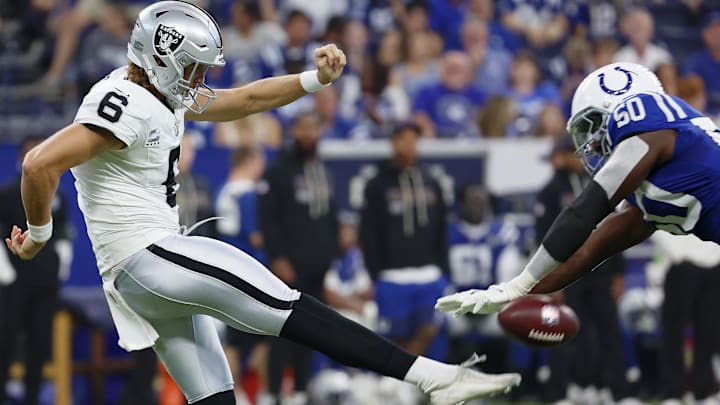 Oct 5, 2025; Indianapolis, Indiana, USA; Indianapolis Colts linebacker Segun Olubi (50) blocks a punt by Las Vegas Raiders punter AJ Cole (6) during the second quarter at Lucas Oil Stadium. Mandatory Credit: Trevor Ruszkowski-Imagn Images