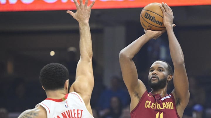 Jan 25, 2025; Cleveland, Ohio, USA; Cleveland Cavaliers forward Evan Mobley (4) shoots a three-point basket beside Houston Rockets guard Fred VanVleet (5) in the first quarter at Rocket Mortgage FieldHouse. Mandatory Credit: David Richard-Imagn Images