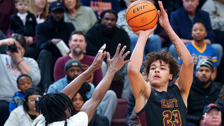 East Peoria’s Quinton Kitt (23) shoots over Peoria High’s Jacob Duffin Jr. in the first half of their high school basketball game Saturday, Jan. 3, 2026 at Peoria High School. The Lions defeated the Raiders 65-61.