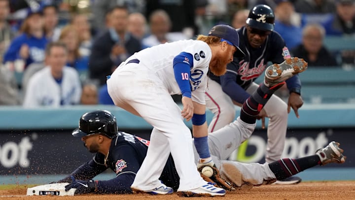 Atlanta Braves left fielder Eddie Rosario (8) is safe at third against Los Angeles Dodgers third baseman Justin Turner (10) after hitting a triple in the third inning during game four of the 2021 NLCS at Dodger Stadium. Atlanta Braves left fielder Eddie Rosario (8) is safe at third against Los Angeles Dodgers third baseman Justin Turner (10) after hitting a triple in the third inning during game four of the 2021 NLCS at Dodger Stadium.