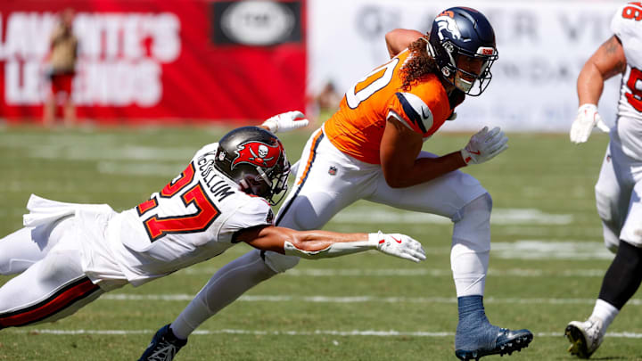 September 22, 2024, Tampa, Florida, USA: Tampa Bay Buccaneers cornerback Zyon McCollum (27) tackles Denver Broncos tight end Greg Dulcich (80) during the third quarter at Raymond James Stadium in Tampa on Sunday, Sept. 22, 2024. September 22, 2024, Tampa, Florida, USA: Tampa Bay Buccaneers cornerback Zyon McCollum (27) tackles Denver Broncos tight end Greg Dulcich (80) during the third quarter at Raymond James Stadium in Tampa on Sunday, Sept. 22, 2024.