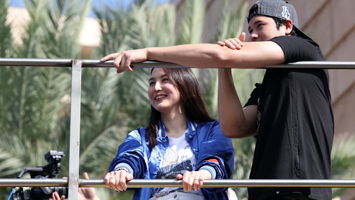 Los Angeles Dodgers two-way player Shohei Ohtani and his wife Mamiko acknowledge the crowd during the World Series championship parade at downtown Los Angeles.