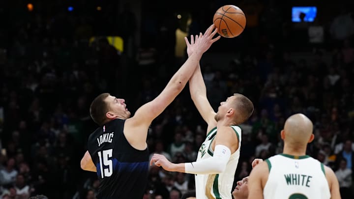 Mar 7, 2024; Denver, Colorado, USA; Boston Celtics center Kristaps Porzingis (8) and Denver Nuggets
