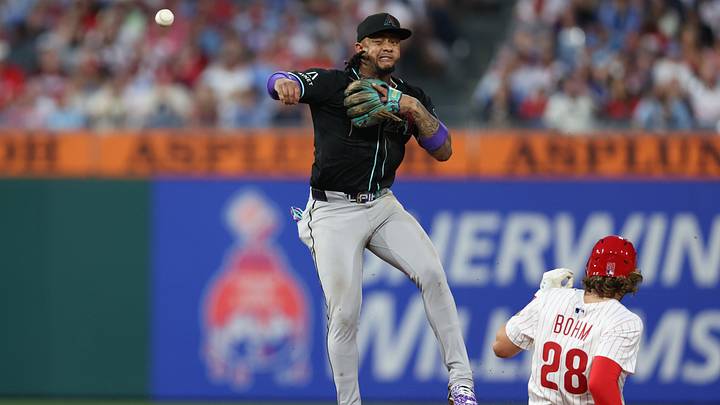 May 3, 2025; Philadelphia, Pennsylvania, USA; Arizona Diamondbacks second base Ketel Marte (4) unsuccessfully throws to first after tagging out Philadelphia Phillies third base Alec Bohm (28) during the fifth inning at Citizens Bank Park. Mandatory Credit: Bill Streicher-Imagn Images