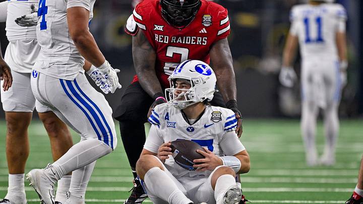 Dec 6, 2025; Arlington, TX, USA; Texas Tech Red Raiders defensive lineman Lee Hunter (2) helps up BYU Cougars quarterback Bear Bachmeier (47) during the game between the Red Raiders and the Cougars at AT&T Stadium. Mandatory Credit: Jerome Miron-Imagn Images