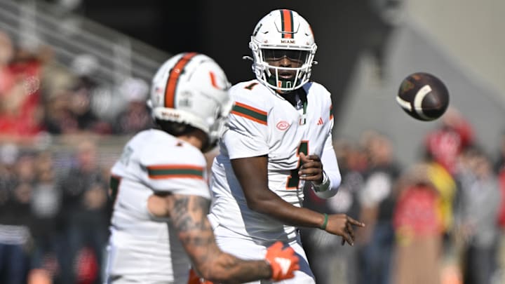 Miami Hurricanes quarterback Cam Ward (1) passes to wide receiver Xavier Restrepo (7) against the Louisville Cardinals during the first quarter at L&N Federal Credit Union Stadium. 