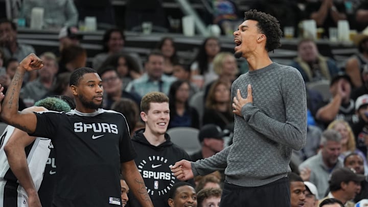Mar 4, 2025; San Antonio, Texas, USA;  San Antonio Spurs guard Blake Wesley (14) and San Antonio Spurs center Victor Wembanyama (1) celebrate on the sideline in the second half against the Brooklyn Nets at Frost Bank Center. Mandatory Credit: Daniel Dunn-Imagn Images