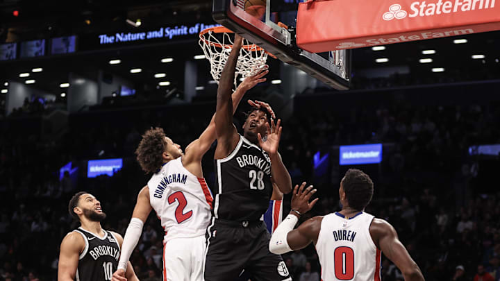 Nov 3, 2024; Brooklyn, New York, USA;  Brooklyn Nets forward Dorian Finney-Smith (28) drives past Detroit Pistons guard Cade Cunningham (2) in the second quarter at Barclays Center. Mandatory Credit: Wendell Cruz-Imagn Images