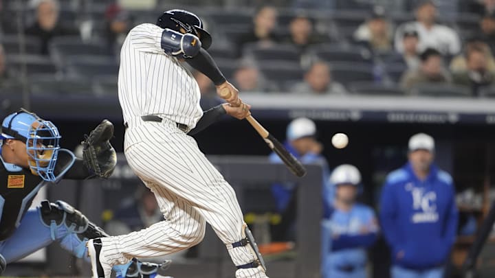 Apr 14, 2025; Bronx, New York, USA; New York Yankees center fielder Trent Grisham (12) hits a home run against the Kansas City Royals during the fifth inning at Yankee Stadium. 