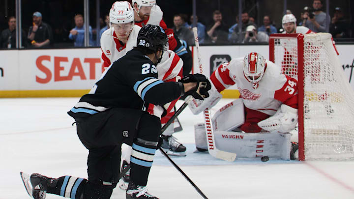 Mar 24, 2025; Salt Lake City, Utah, USA; Utah Hockey Club center Jack McBain (22) takes a shot on Detroit Red Wings goaltender Alex Lyon (34) during the third period at Delta Center. Mandatory Credit: Rob Gray-Imagn Images