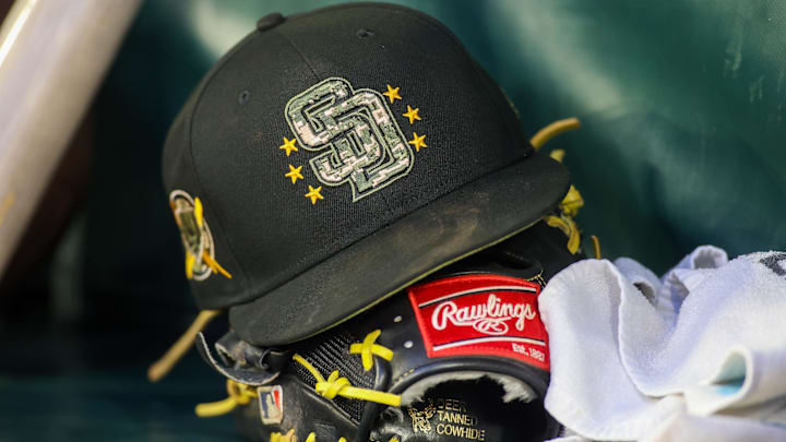 May 17, 2024; Atlanta, Georgia, USA; A detailed view of a San Diego Padres hat and glove on the bench against the Atlanta Braves in the third inning at Truist Park. Mandatory Credit: Brett Davis-Imagn Images May 17, 2024; Atlanta, Georgia, USA; A detailed view of a San Diego Padres hat and glove on the bench against the Atlanta Braves in the third inning at Truist Park. Mandatory Credit: Brett Davis-Imagn Images