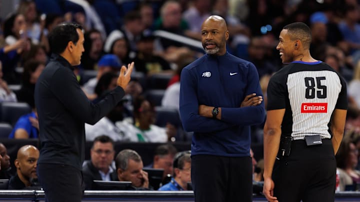 Oct 12, 2025; Orlando, Florida, USA; Miami Heat Head Coach Erik Spoelstra, Orlando Magic Head Coach Jamahl Mosley and NBA referee Robert Hussey react during a free throw during the first half at Kia Center. Mandatory Credit: Matt Pendleton-Imagn Images