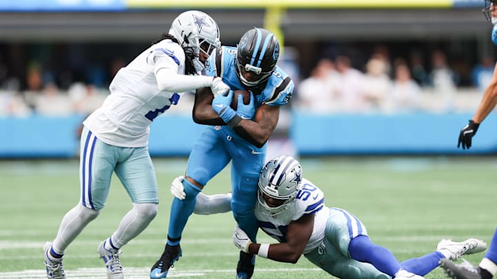 Carolina Panthers running back Rico Dowdle runs with the ball while being tackled by Dallas Cowboys linebacker Shemar James.