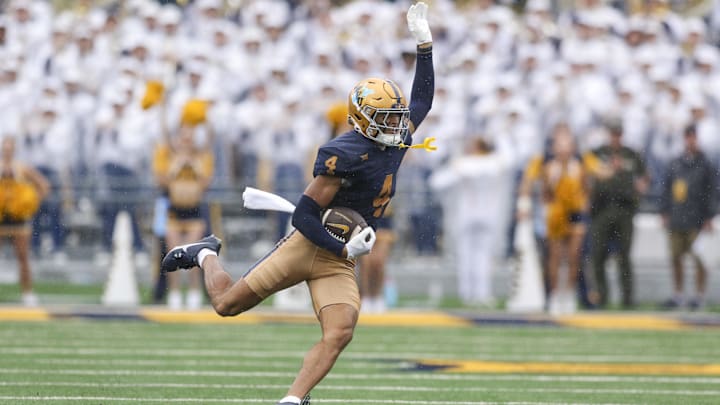 Sep 27, 2025; Morgantown, West Virginia, USA; West Virginia Mountaineers wide receiver Cam Vaughn (4) makes a catch during the first quarter against the Utah Utes at Milan Puskar Stadium. Mandatory Credit: Ben Queen-Imagn Images