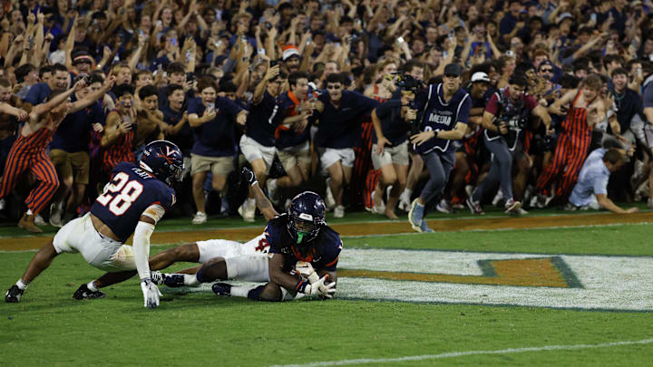 Sep 26, 2025; Charlottesville, Virginia, USA; Virginia Cavaliers defensive back Ja'son Prevard (10) is hugged by Cavaliers defensive back Donavon Platt (28) as fans storm the field after making a game winning interception in the end zone on a pass intended for Florida State Seminoles wide receiver Squirrel White (4) in the second overtime at Scott Stadium. Mandatory Credit: Geoff Burke-Imagn Images Sep 26, 2025; Charlottesville, Virginia, USA; Virginia Cavaliers defensive back Ja'son Prevard (10) is hugged by Cavaliers defensive back Donavon Platt (28) as fans storm the field after making a game winning interception in the end zone on a pass intended for Florida State Seminoles wide receiver Squirrel White (4) in the second overtime at Scott Stadium. Mandatory Credit: Geoff Burke-Imagn Images