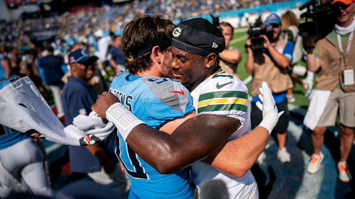 Green Bay Packers QB Malik Willis embraces Tennessee Titans LB Jack Gibbens after the Packers' 30-14 win on Sunday.