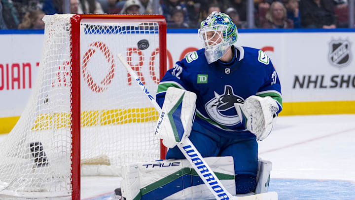 Feb 8, 2025; Vancouver, British Columbia, CAN; Vancouver Canucks goalie Kevin Lankinen (32) watches the flying puck against the Toronto Maple Leafs in the third period at Rogers Arena. Mandatory Credit: Bob Frid-Imagn Images