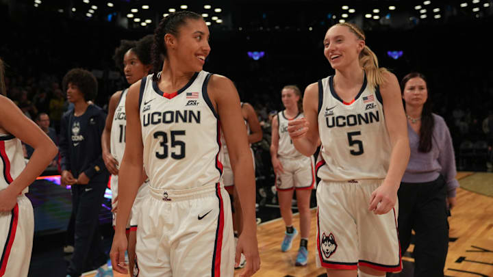 Dec 7, 2024; Brooklyn, New York, USA; Connecticut Huskies guard Azzi Fudd (35) and Connecticut Huskies guard Paige Bueckers (5) celebrate after the game against the Louisville Cardinals at Barclays Center. Mandatory Credit: Lucas Boland-Imagn Images