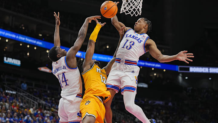 Dec 7, 2025; Kansas City, Missouri, USA; Missouri Tigers guard Sebastian Mack (12) shoots against Kansas Jayhawks guard Melvin Council Jr. (14) and guard Elmarko Jackson (13) during the second half at T-Mobile Center. Mandatory Credit: Jay Biggerstaff-Imagn Images Dec 7, 2025; Kansas City, Missouri, USA; Missouri Tigers guard Sebastian Mack (12) shoots against Kansas Jayhawks guard Melvin Council Jr. (14) and guard Elmarko Jackson (13) during the second half at T-Mobile Center. Mandatory Credit: Jay Biggerstaff-Imagn Images