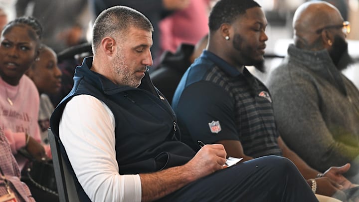 Mar 13, 2025; Foxborough, MA, USA; New England Patriots head coach Mike Vrabel takes notes at a press conference at the GP Atrium at Gillette Stadium. Mandatory Credit: Eric Canha-Imagn Images