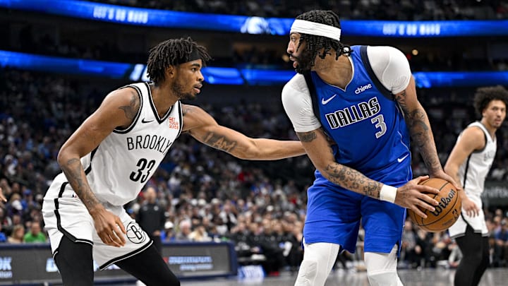 Mar 31, 2025; Dallas, Texas, USA; Dallas Mavericks forward Anthony Davis (3) looks to move the ball past Brooklyn Nets center Nic Claxton (33) during the second quarter at the American Airlines Center. Mandatory Credit: Jerome Miron-Imagn Images
