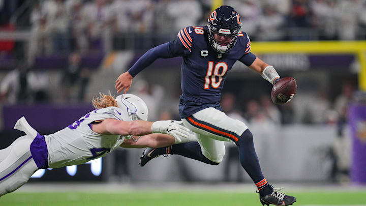 Dec 16, 2024; Minneapolis, Minnesota, USA; Chicago Bears quarterback Caleb Williams (18) scrambles against the Minnesota Vikings linebacker Andrew Van Ginkel (43) in the second quarter at U.S. Bank Stadium. Mandatory Credit: Brad Rempel-Imagn Images