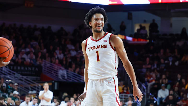 Feb 1, 2025; Los Angeles, California, USA;  USC Trojans guard Desmond Claude (1) smiles while shooting a free throw against the Michigan State Spartans during the first half at Galen Center. Mandatory Credit: William Navarro-Imagn Images