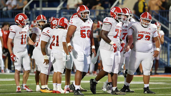 Orange Lutheran offense breaks huddle before an offensive play.