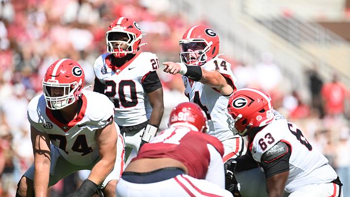 Georgia Bulldogs quarterback Gunner Stockton communicates with his offensive line before calling for the snap against the Arkansas Razorbacks in Fayetteville, Arkansas on 9/19/2026. Georgia Bulldogs quarterback Gunner Stockton communicates with his offensive line before calling for the snap against the Arkansas Razorbacks in Fayetteville, Arkansas on 9/19/2026.