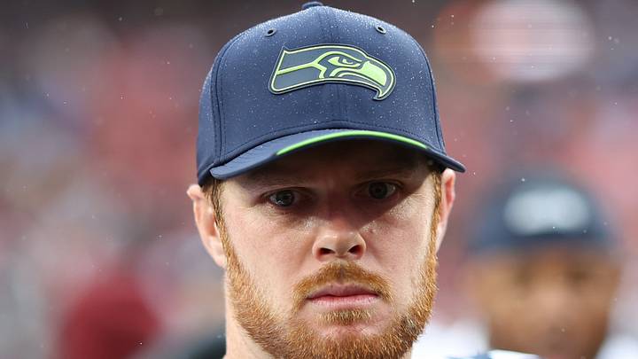 Seattle Seahawks quarterback Sam Darnold stands on the field