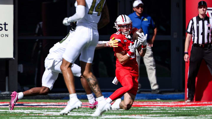 Oct 19, 2024; Tucson, Arizona, USA; Arizona Wildcats defensive back Jack Luttrell (13) intercepts a ball against the Colorado Buffaloes during the second quarter at Arizona Stadium.
