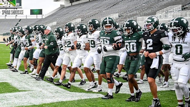 Michigan State's head coach Pat Fitzgerald and the team walk across the end zone during the football Spring Showcase on Saturday, April 18, 2026, at Spartan Stadium in East Lansing.