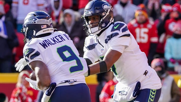 Dec 24, 2022; Kansas City, Missouri, USA; Seattle Seahawks quarterback Geno Smith (7) hands off to running back Kenneth Walker III (9) against the Kansas City Chiefs during the game at GEHA Field at Arrowhead Stadium. Mandatory Credit: Denny Medley-Imagn Images