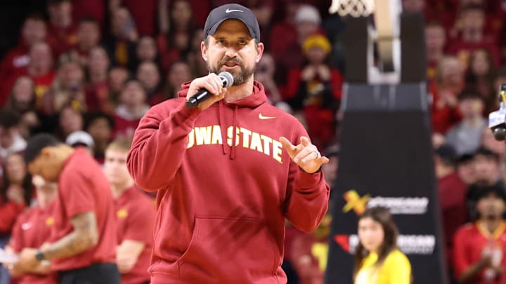 Dec 11, 2025; Ames, Iowa, USA; Iowa State Cyclones new football coach Jimmy Rogers speaks during the Cyclones game with the Iowa Hawkeyes during the first half at James H. Hilton Coliseum. Mandatory Credit: Reese Strickland-Imagn Images Dec 11, 2025; Ames, Iowa, USA; Iowa State Cyclones new football coach Jimmy Rogers speaks during the Cyclones game with the Iowa Hawkeyes during the first half at James H. Hilton Coliseum. Mandatory Credit: Reese Strickland-Imagn Images