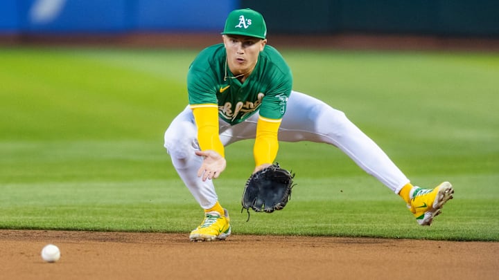 Sep 20, 2024; Oakland, California, USA; Oakland Athletics second base Zack Gelof (20) fields a grounder during the third inning against the New York Yankees at Oakland-Alameda County Coliseum. Mandatory Credit: Bob Kupbens-Imagn Images