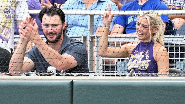 Jun 16, 2025; Omaha, Neb, USA;  LSU Tiger alumni Paul Skenes and Livvy Dunne watch action against the UCLA Bruinsat Charles Schwab Field. Mandatory Credit: Steven Branscombe-Imagn Images