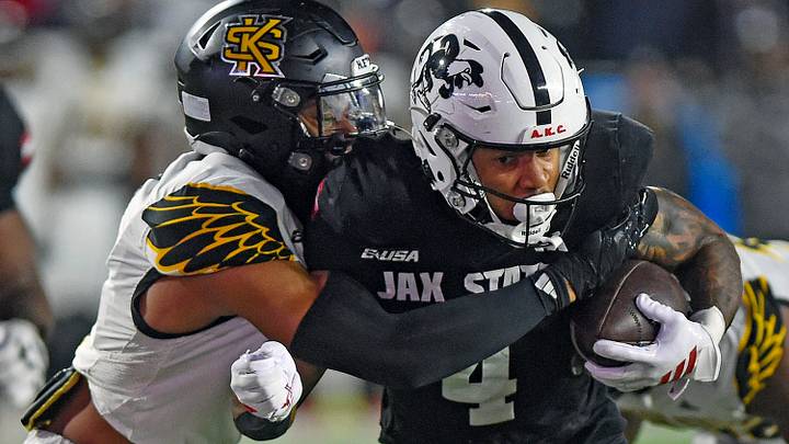 Jax State's Cam Cook tries to evade the tackle of Kennesaw State's Alexander Ford during the C-USA Championship at AmFirst Stadium in Jacksonville, Alabama December 5, 2025. (Dave Hyatt / Hyatt Media LLC)