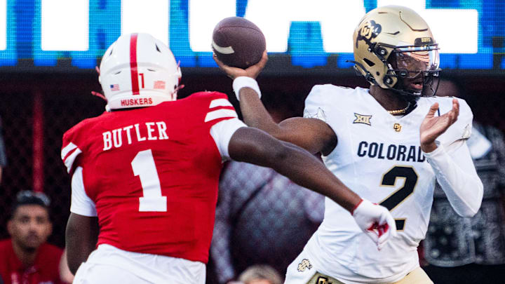 Colorado quarterback Shedeur Sanders passes under pressure from Nebraska defensive end Jimari Butler during the teams' 2024 game in Lincoln. Nebraska head coach Matt Rhule said Monday that Butler and defensive back Marques Buford Jr. plan to return next year for their final season of eligibility.  