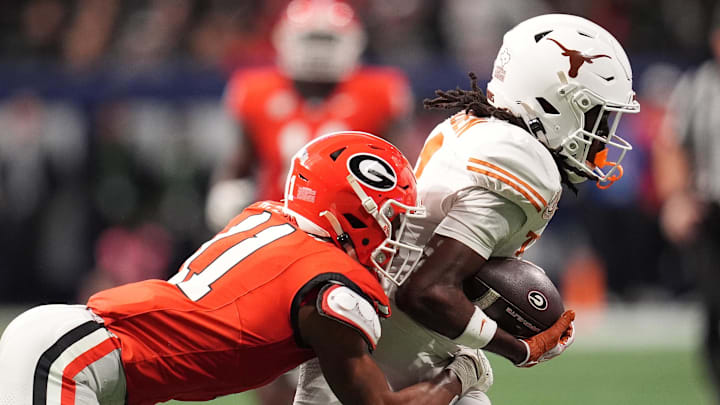 Dec 7, 2024; Atlanta, GA, USA; Texas Longhorns wide receiver Silas Bolden (11) makes a catch agaistn Georgia Bulldogs linebacker Jalon Walker (11) during the first half in the 2024 SEC Championship game at Mercedes-Benz Stadium. Mandatory Credit: Dale Zanine-Imagn Images