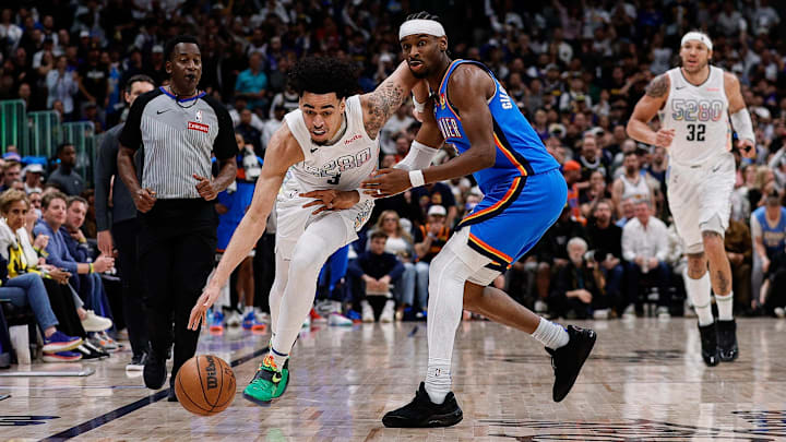 May 15, 2025; Denver, Colorado, USA; Denver Nuggets guard Julian Strawther (3) controls the ball as Oklahoma City Thunder guard Shai Gilgeous-Alexander (2) guards in the fourth quarter during game six of the second round for the 2025 NBA Playoffs at Ball Arena. Mandatory Credit: Isaiah J. Downing-Imagn Images