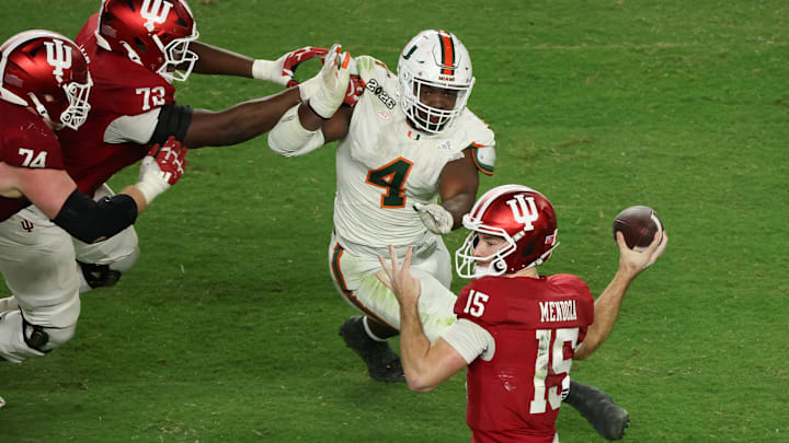 Jan 19, 2026; Miami Gardens, FL, USA; Indiana Hoosiers quarterback Fernando Mendoza (15) passes the ball under pressure by Miami Hurricanes defensive lineman Rueben Bain Jr. (4) in the third quarter during the College Football Playoff National Championship game at Hard Rock Stadium. Mandatory Credit: Kim Klement Neitzel-Imagn Images