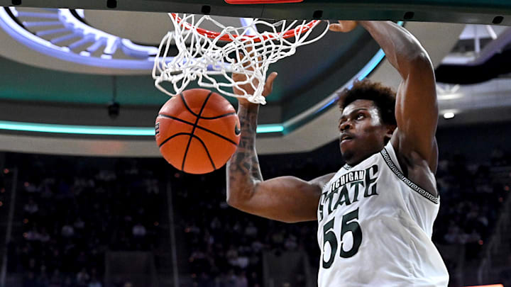Feb 17, 2026; East Lansing, Michigan, USA; Michigan State Spartans forward Coen Carr (55) gets a slam dunk against the UCLA Bruins during the second half at Jack Breslin Student Events Center. Mandatory Credit: Dale Young-Imagn Images