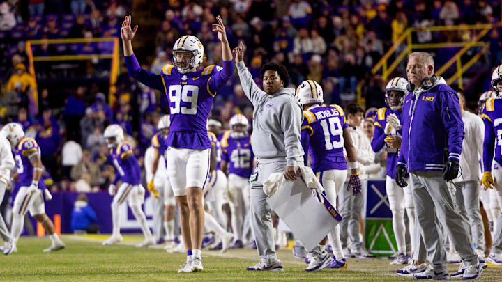 Nov 30, 2024; Baton Rouge, Louisiana, USA;  LSU Tigers defensive tackle Gio Paez (99) and head coach Brian Kelly react to a field goal made against the Oklahoma Sooners during the fourth quarter at Tiger Stadium. Mandatory Credit: Stephen Lew-Imagn Images