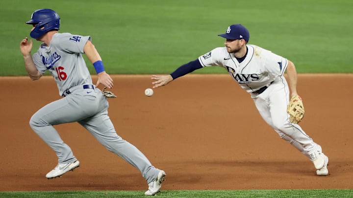 Oct 23, 2020; Arlington, Texas, USA; Tampa Bay Rays second baseman Brandon Lowe (right) throws to second base to force Los Angeles Dodgers designated hitter Will Smith (16) during the seventh inning of game three of the 2020 World Series at Globe Life Field. Mandatory Credit: Kevin Jairaj-Imagn Images