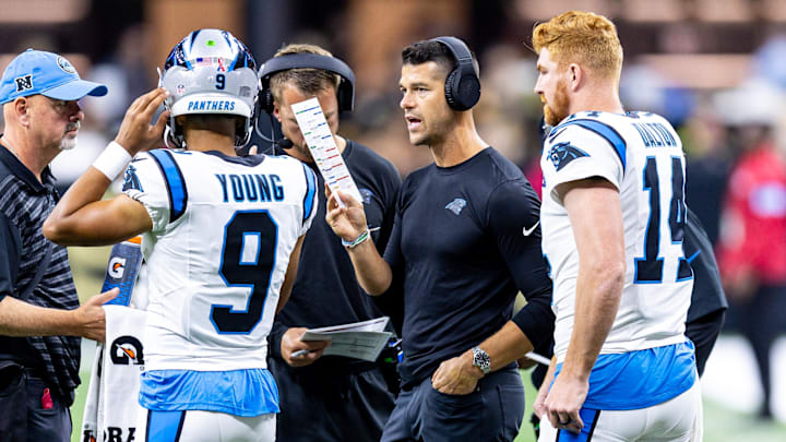 Sep 8, 2024; New Orleans, Louisiana, USA;  Carolina Panthers head coach Dave Canales talks to quarterback Bryce Young (9) and quarterback Andy Dalton (14) on a time out against the New Orleans Saints during the first half at Caesars Superdome. Mandatory Credit: Stephen Lew-Imagn Images